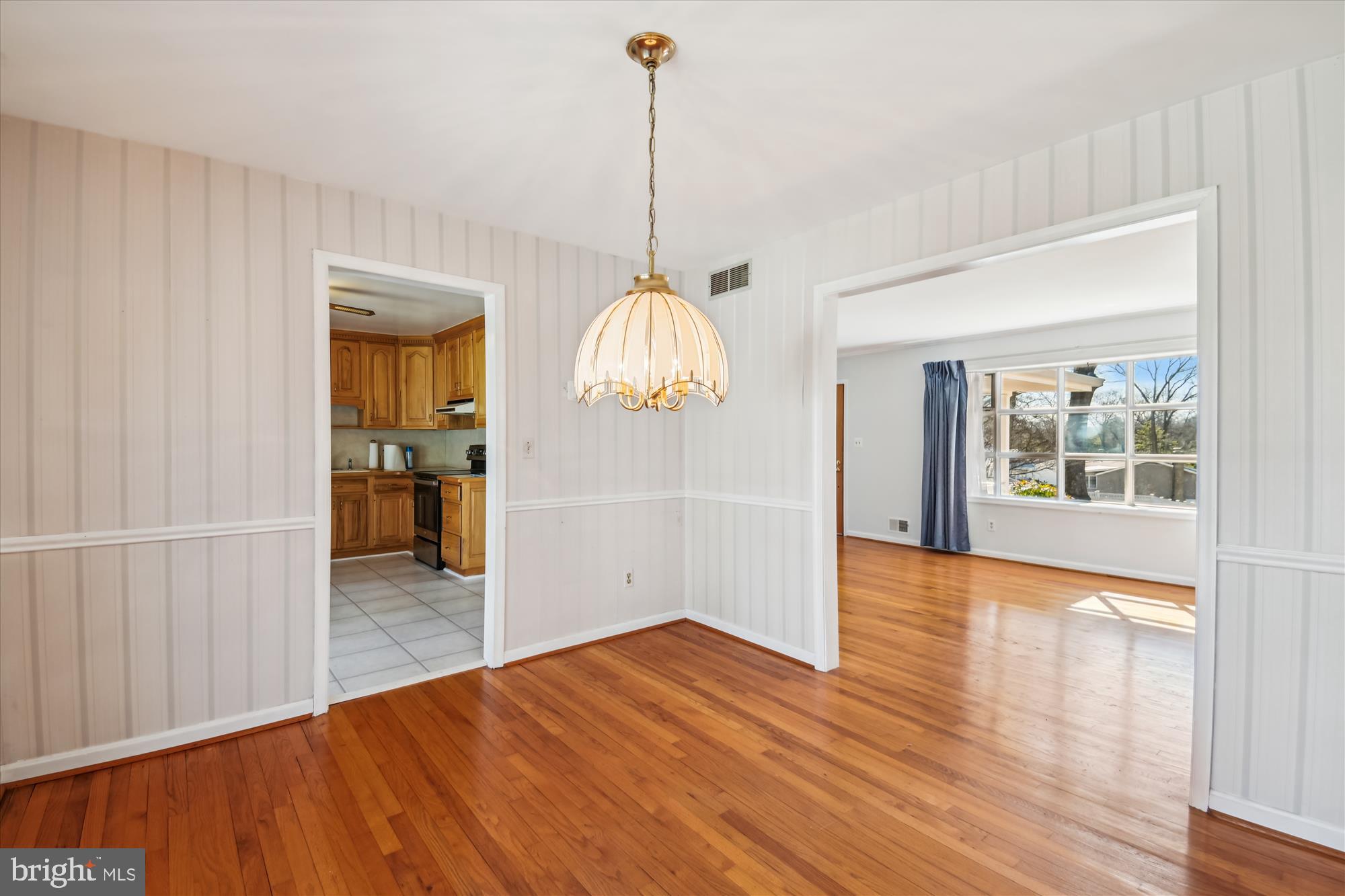 1574 Melanie Road Pasadena, MD 21122 - Photo 8 of 41 a view of a room with wooden floor ceiling fan and window