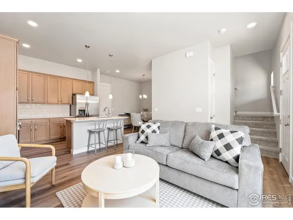 a living room with furniture and kitchen view
