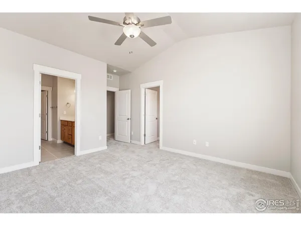 a view of an empty room and a ceiling fan