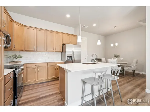 a kitchen with a table chairs stove and cabinets