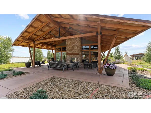 a backyard of a house with barbeque oven table and chairs