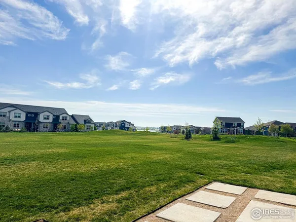 a view of a grassy field with an trees