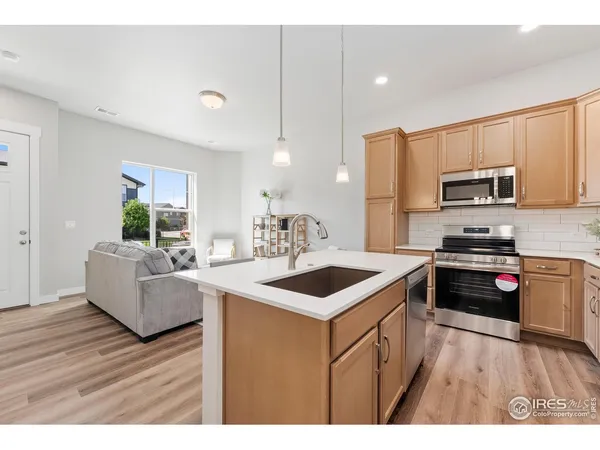 a kitchen with stove a sink and refrigerator