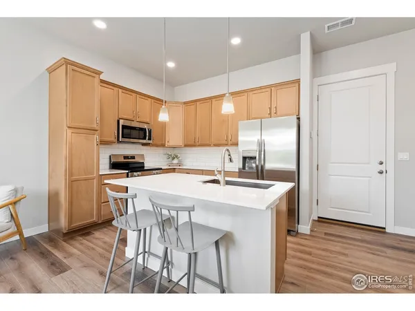 a kitchen with kitchen island a sink appliances and cabinets