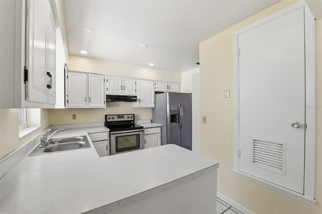6229 Dalton Street Spring Hill, FL 34606 - Photo 11 of 44 a kitchen with granite countertop a refrigerator stove and sink