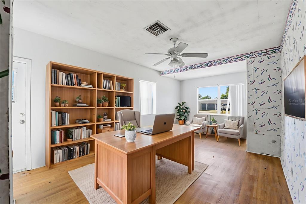 6229 Dalton Street Spring Hill, FL 34606 - Photo 15 of 44 a work room with furniture large window and wooden floor