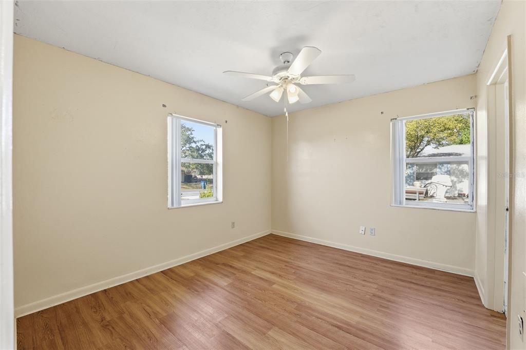 6229 Dalton Street Spring Hill, FL 34606 - Photo 17 of 44 a view of empty room with wooden floor and fan