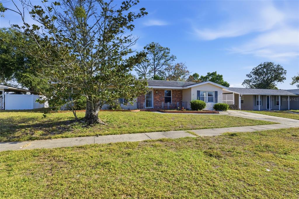 6229 Dalton Street Spring Hill, FL 34606 - Photo 36 of 44 a front view of a house with a yard