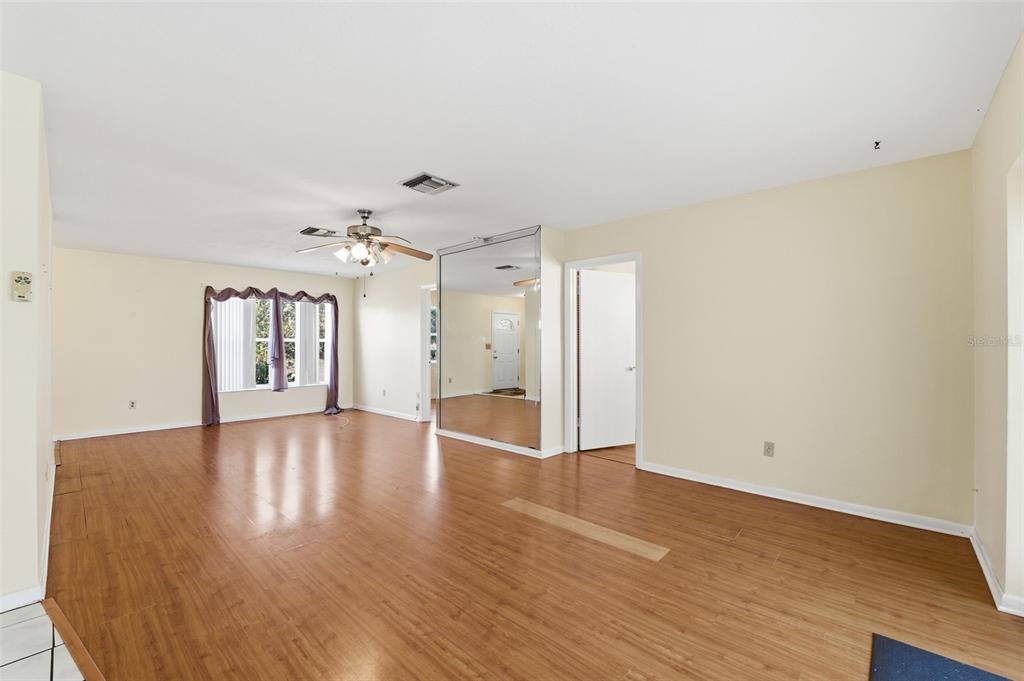 6229 Dalton Street Spring Hill, FL 34606 - Photo 37 of 44 a view of an empty room with window and wooden floor