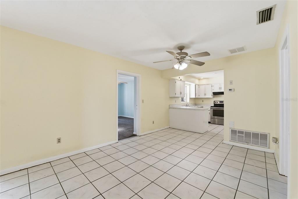 6229 Dalton Street Spring Hill, FL 34606 - Photo 39 of 44 a view of a kitchen with wooden cabinet and a refrigerator