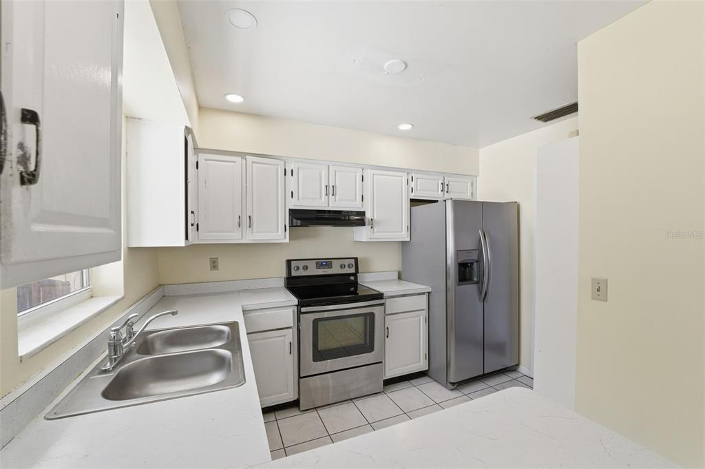 6229 Dalton Street Spring Hill, FL 34606 - Photo 41 of 44 a kitchen with a sink cabinets and stainless steel appliances