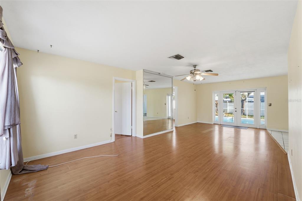 6229 Dalton Street Spring Hill, FL 34606 - Photo 5 of 44 wooden floor in an empty room with a window