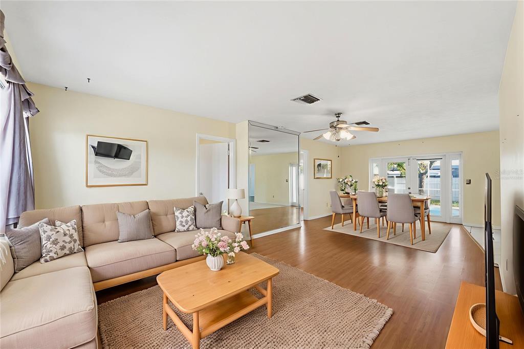6229 Dalton Street Spring Hill, FL 34606 - Photo 6 of 44 a living room with furniture wooden floor and a large window