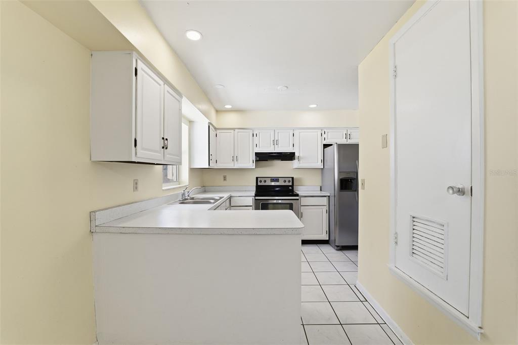 6229 Dalton Street Spring Hill, FL 34606 - Photo 10 of 44 a kitchen with a sink a refrigerator and cabinets