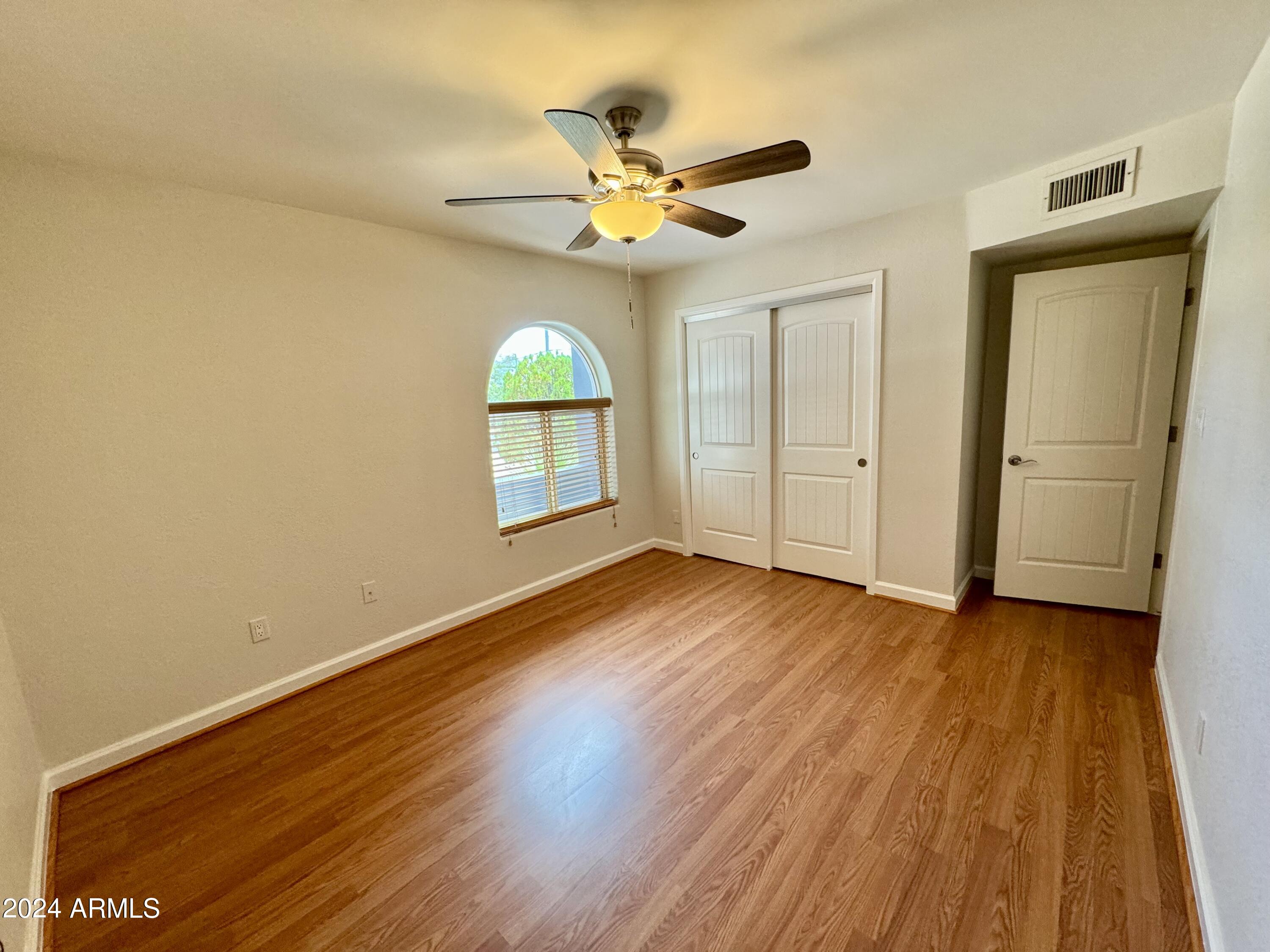 15402 North 57th Street Scottsdale, AZ 85254 - Photo 25 of 35 wooden floor in an empty room with a window