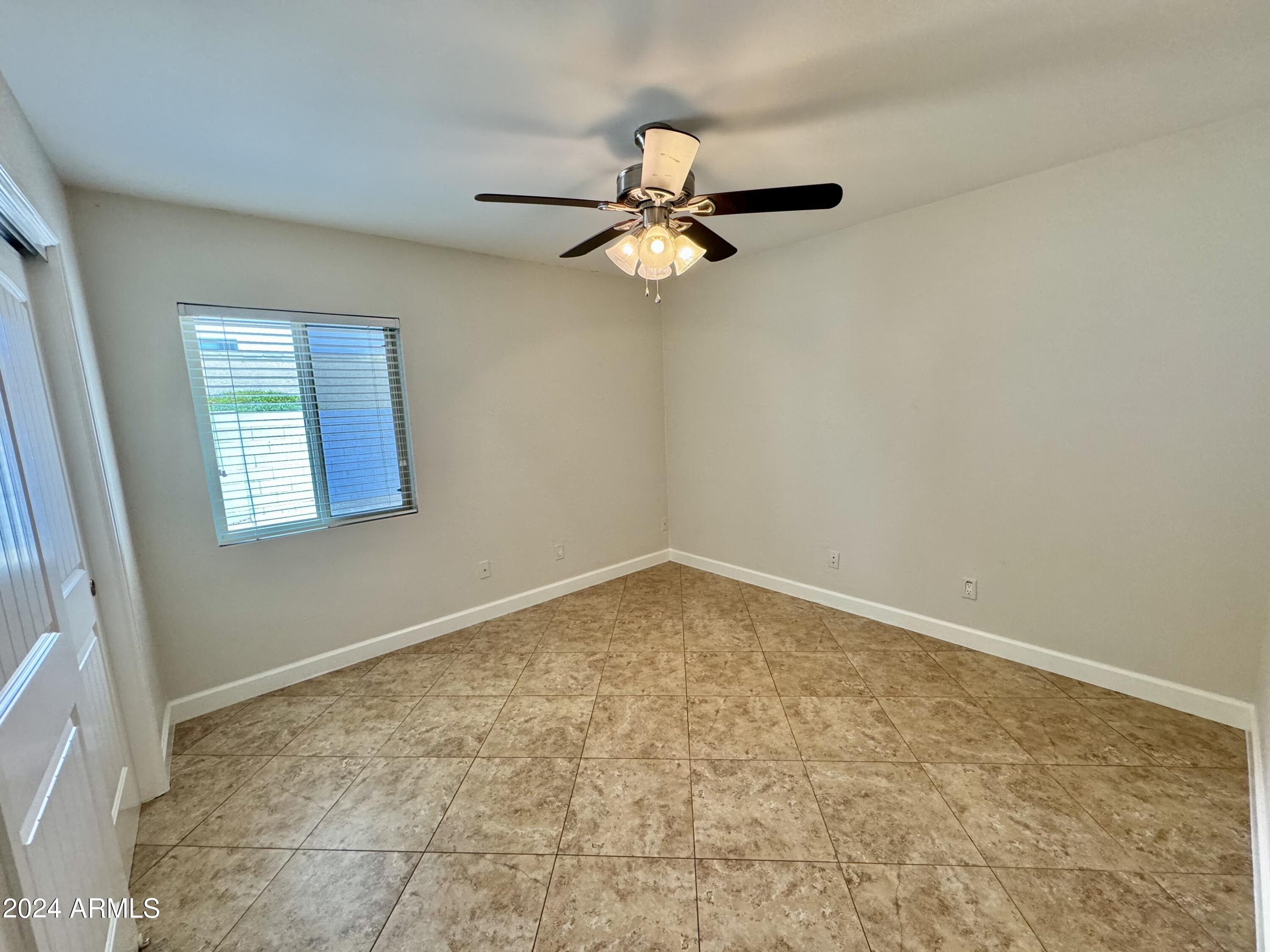 15402 North 57th Street Scottsdale, AZ 85254 - Photo 26 of 35 an empty room with a window and ceiling fan