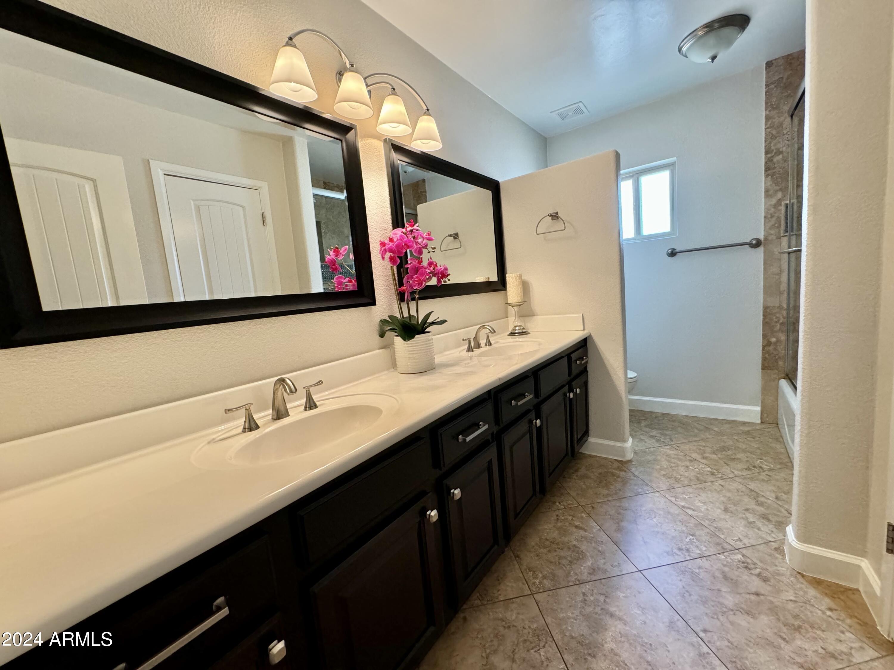 15402 North 57th Street Scottsdale, AZ 85254 - Photo 28 of 35 a bathroom with a double vanity sink a mirror and a bathtub