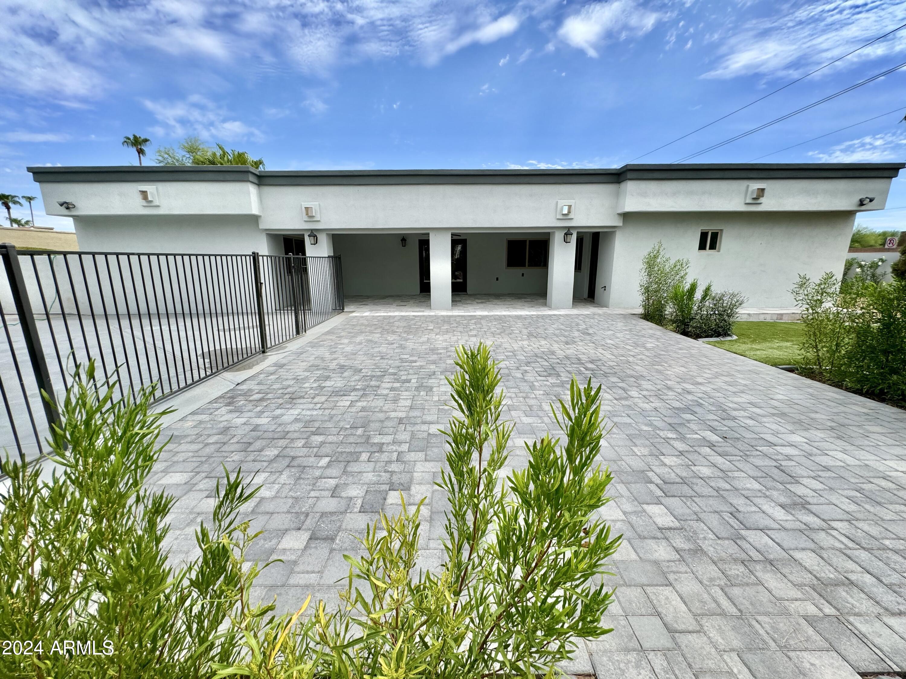 15402 North 57th Street Scottsdale, AZ 85254 - Photo 3 of 35 a front view of a house with a yard