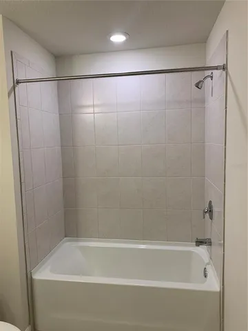 a bathroom with a shower and a bath tub