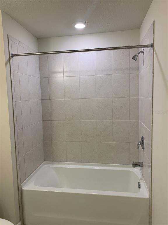 2559 Buena View Road Kissimmee, FL 34746 - Photo 14 of 17 a bathroom with a shower and a bath tub