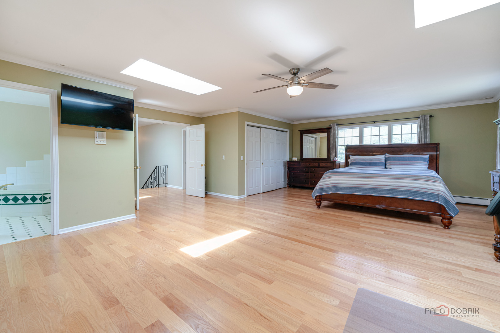 357 Roberts Road Inverness, IL 60010 - Photo 28 of 50 a spacious bedroom with a bed and a flat screen tv