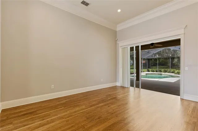 a view of a room with wooden floor chandelier and a ceiling fan