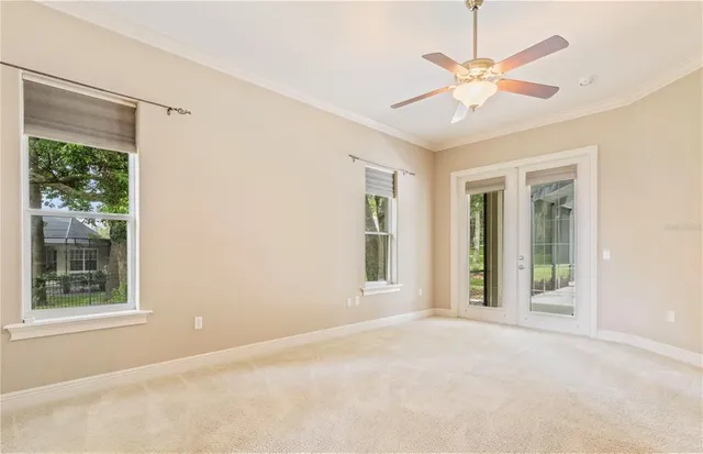 an empty room with a window and a fan