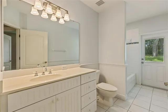 a view of a white building with swimming pool in front of it