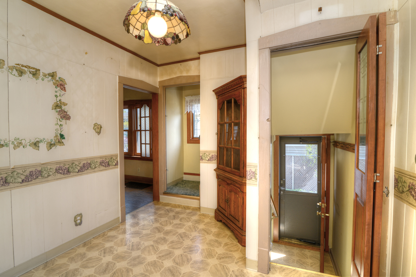 4162 Blanchan Avenue Brookfield, IL 60513 - Photo 18 of 39 a view of a hallway with a dining room and chandelier