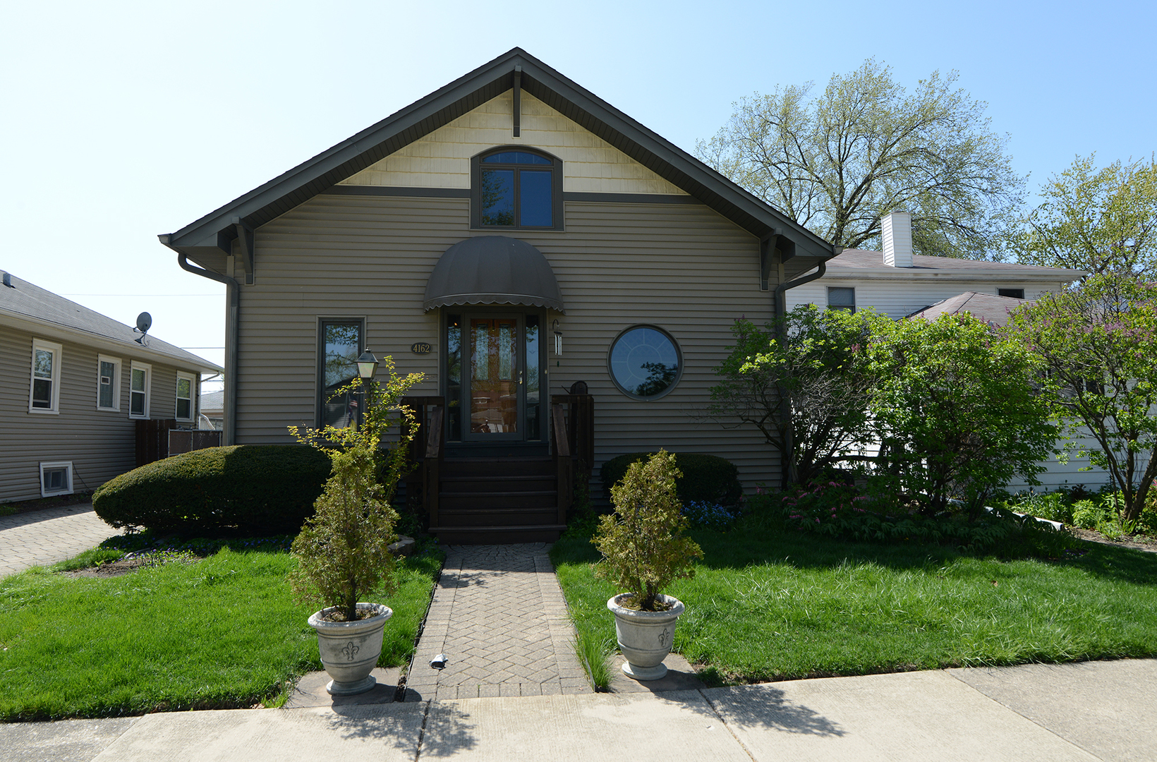 4162 Blanchan Avenue Brookfield, IL 60513 - Photo 2 of 39 a front view of a house with garden