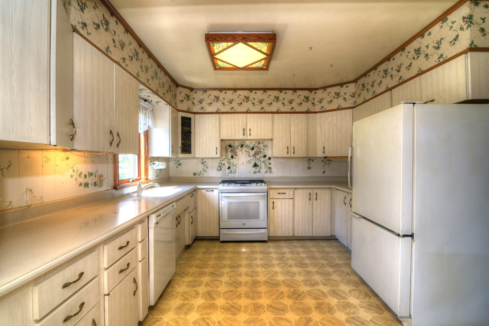 4162 Blanchan Avenue Brookfield, IL 60513 - Photo 23 of 39 a kitchen with a sink stove and refrigerator