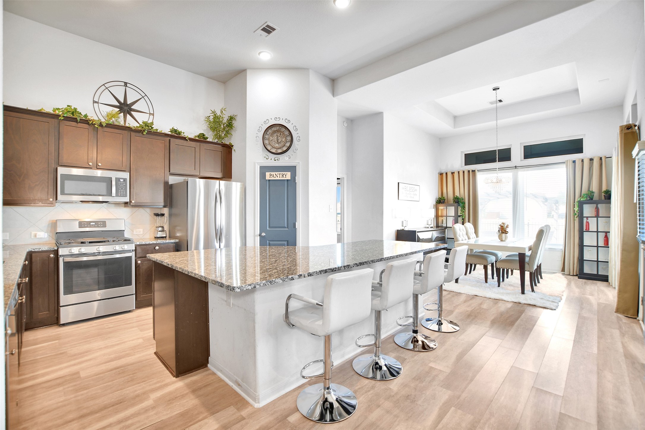 27 Montecito Lane Manvel, TX 77578 - Photo 16 of 49 a large kitchen with stainless steel appliances lots of counter top space and wooden floor