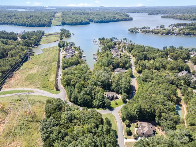 an aerial view of ocean with residential house with outdoor space and seating