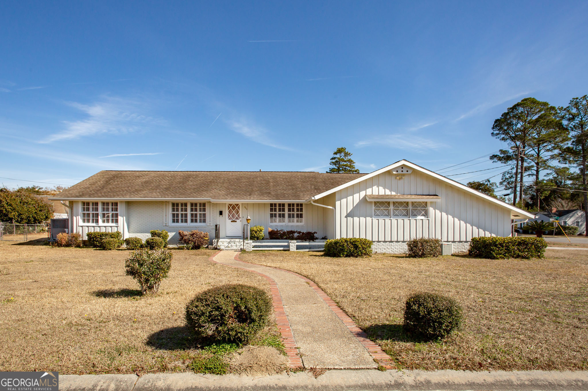 a front view of a residential apartment building with a yard