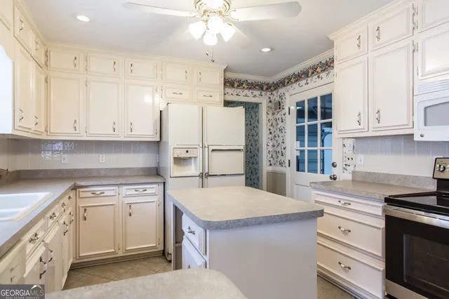 a kitchen with a white cabinets and refrigerator