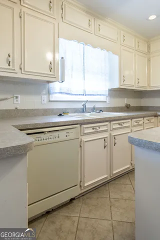 a kitchen with cabinets appliances and a window