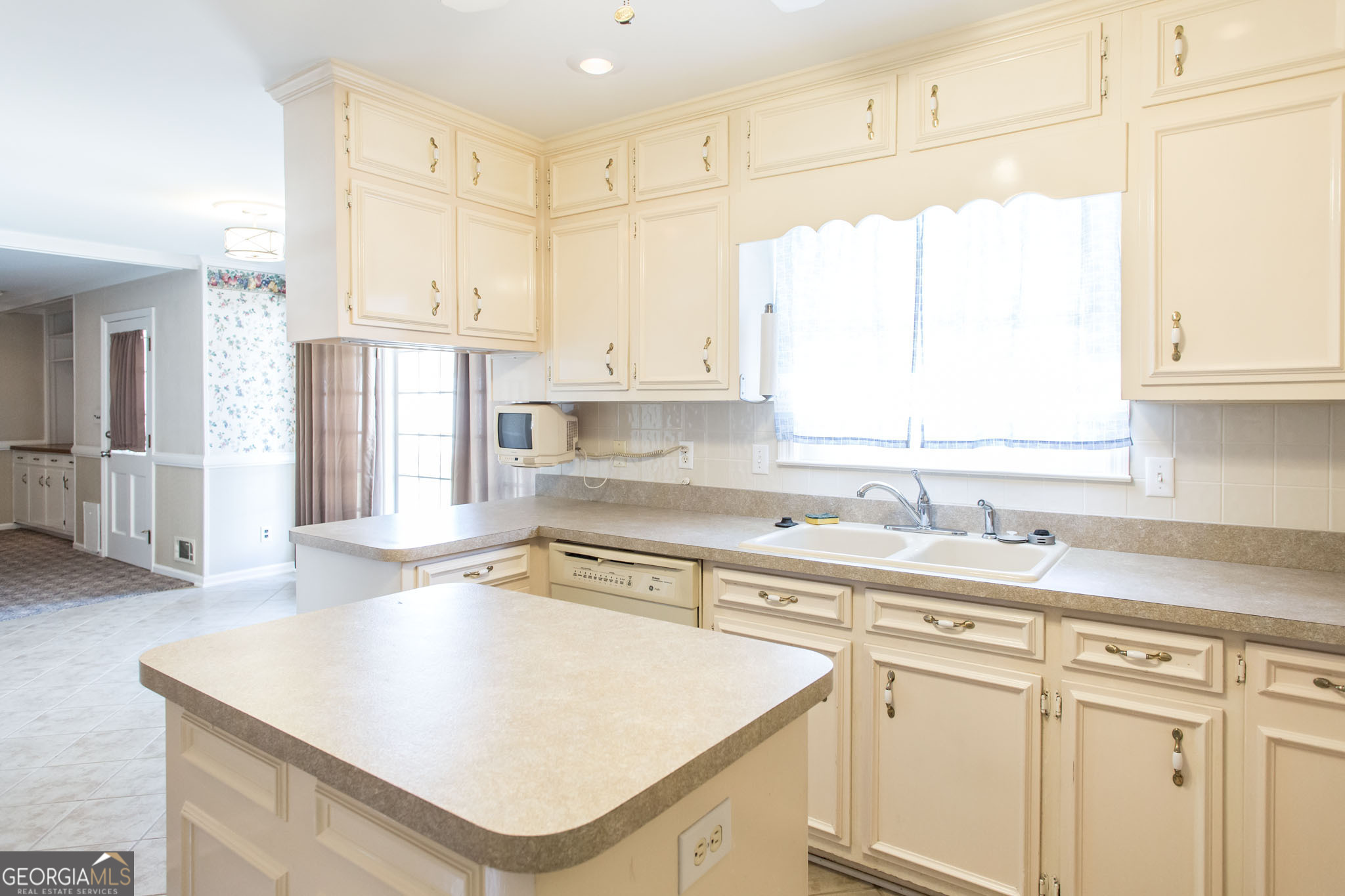 402 Preston Street Waycross, GA 31501 - Photo 17 of 43 a kitchen with stainless steel appliances granite countertop a sink a stove and white cabinets with wooden floor