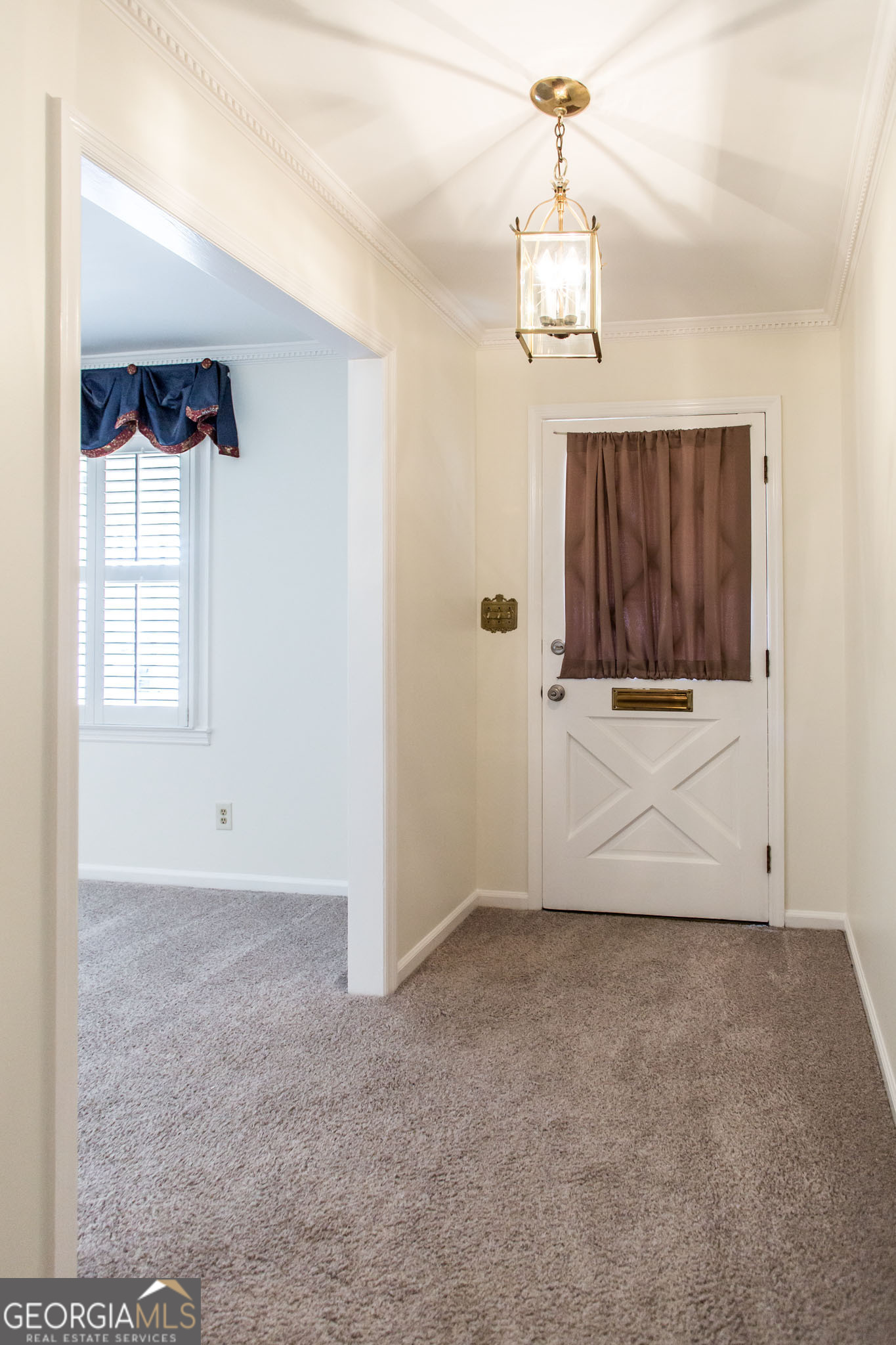 402 Preston Street Waycross, GA 31501 - Photo 2 of 43 an empty room with windows and cabinet