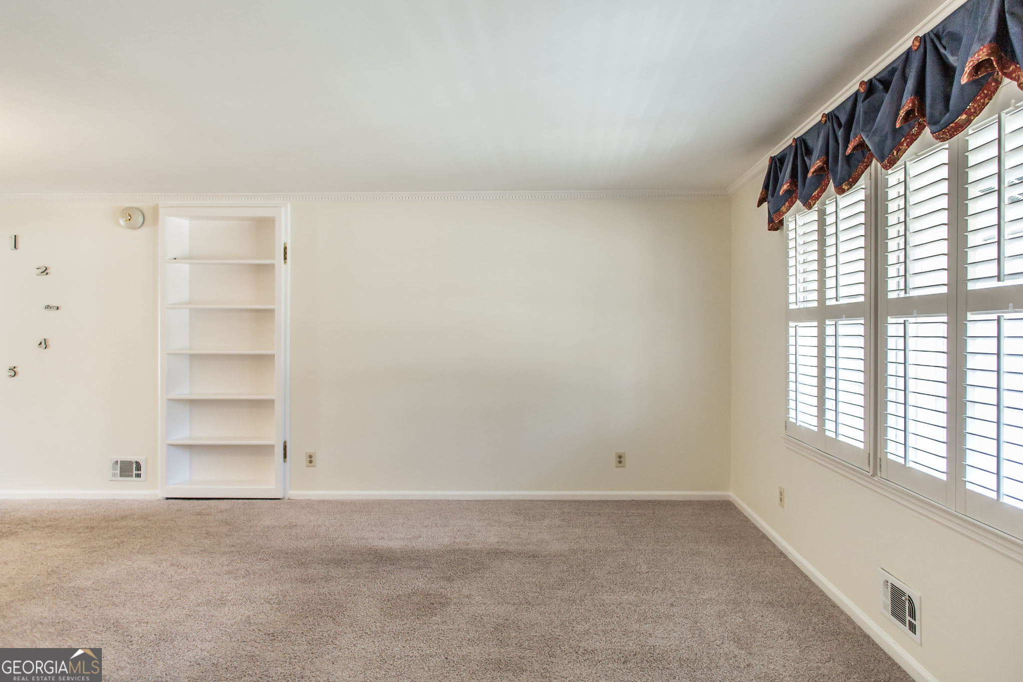 402 Preston Street Waycross, GA 31501 - Photo 3 of 43 wooden floor in an empty room with a window