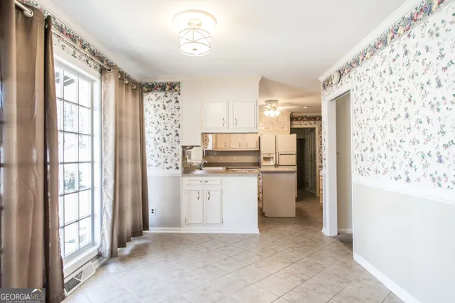 a kitchen with a refrigerator and a stove