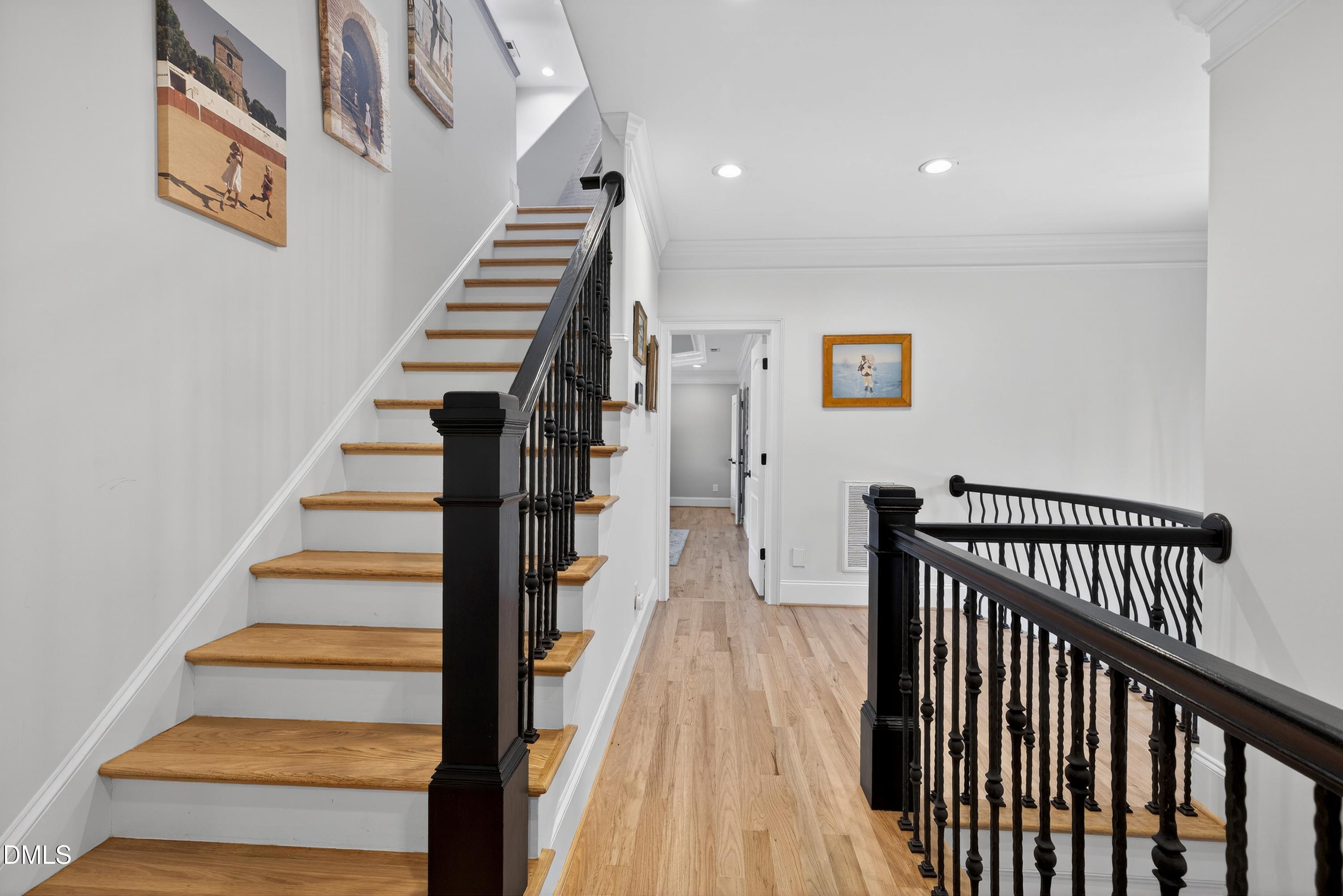 6701 Foxfire Place Raleigh, NC 27615 - Photo 40 of 67 a view of entryway with stairs and wooden floor
