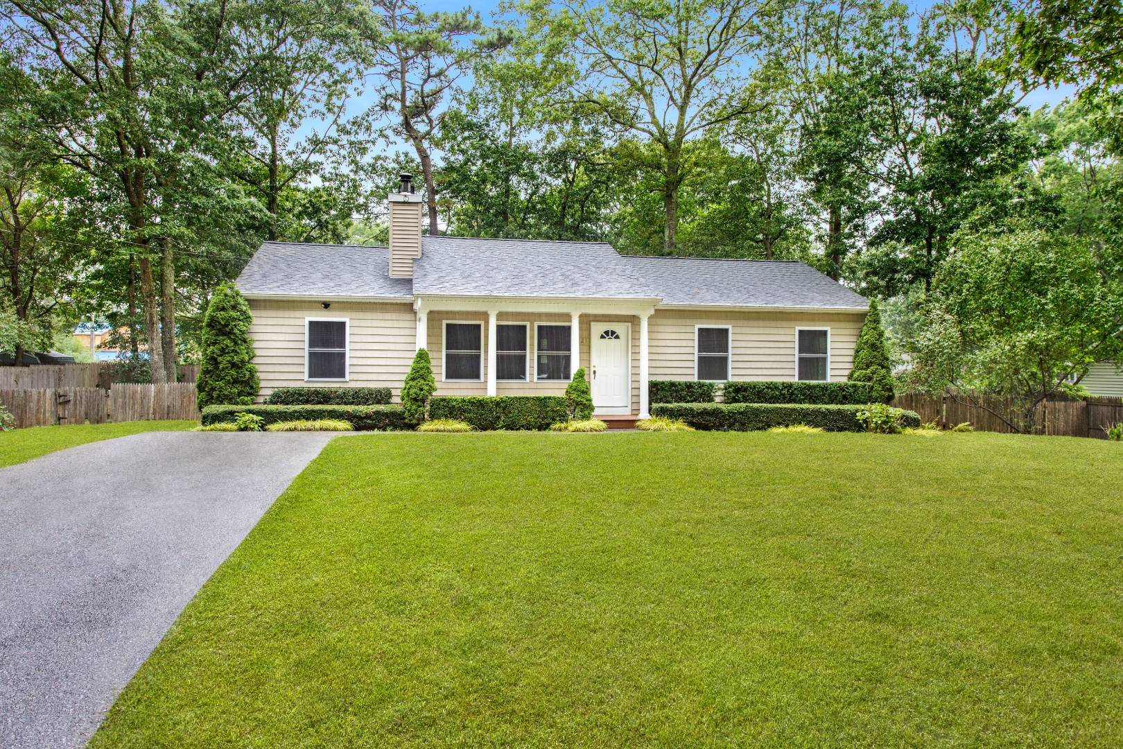 123 Flanders Blouevard Flanders, NY 11901 - Photo 1 of 7 a front view of a house with a yard table and chairs