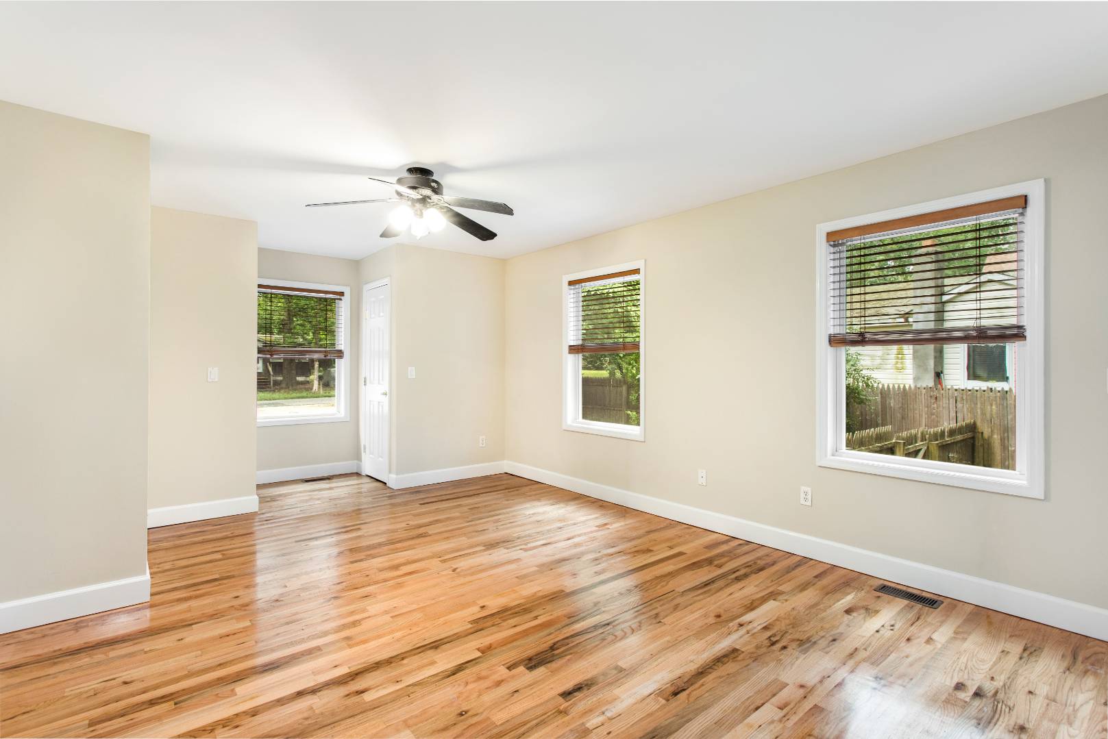 123 Flanders Blouevard Flanders, NY 11901 - Photo 4 of 7 a view of an empty room with wooden floor and a window