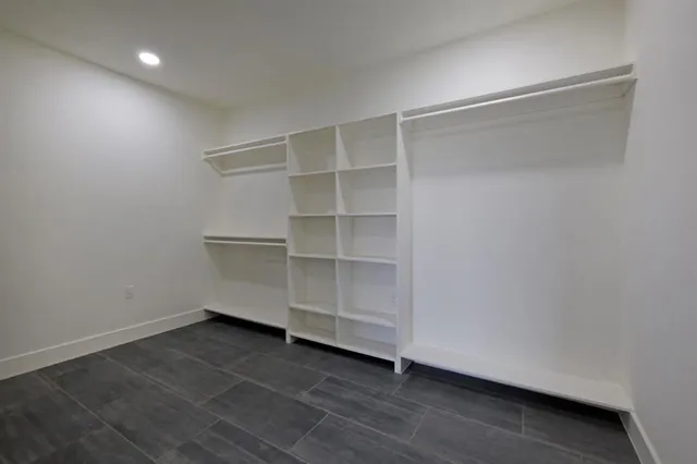 a view of an empty room with a closet