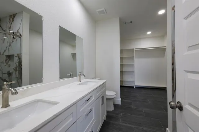 a bathroom with a double vanity sink a mirror and shower