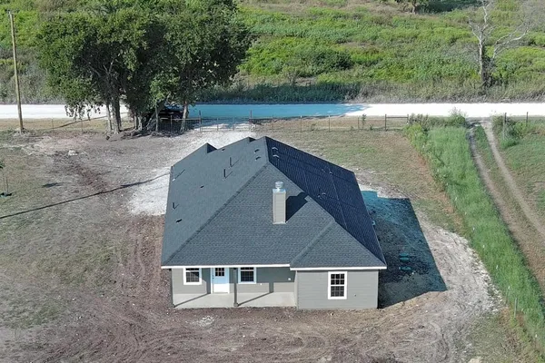a view of a house with a backyard