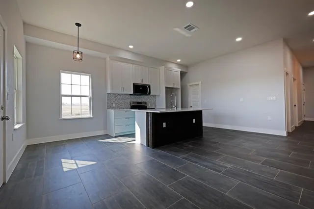 a room with wooden floors and white walls