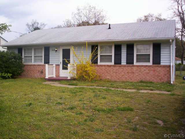 a view of a house with a yard and sitting area