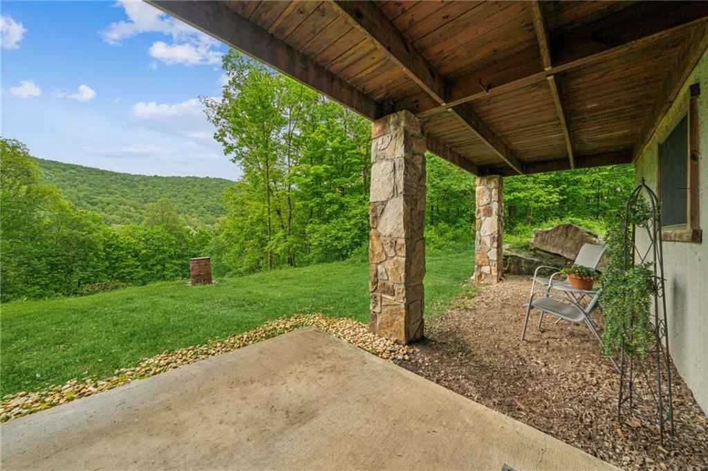 905 Indian Creek Valley Road Normalville, PA 15469 - Photo 10 of 38 a view of a backyard with table and chairs under a large tree