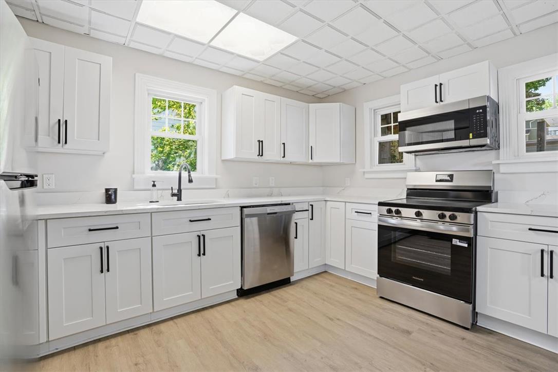 110 Messinger Street Bangor, PA 18013 - Photo 5 of 39 Bright, airy kitchen features gleaming white cabinetry, modern appliances, and durable flooring.